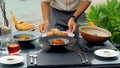 At a seaside restaurant, a waiter serves a table overlooking the ocean Royalty Free Stock Photo