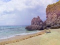 Seaside scene with mountain. Aqua blue sea water and yellow sand beach.