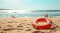 Seaside serenity: A lifebuoy drifting on a sunlit beach, surrounded by the warmth of golden sands and soothing waves