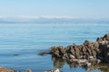 Seaside, snowy mountains and blue sky