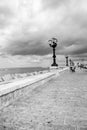 Seaside with street lamps in perspective black and white. Adriatic seascape monochrome. Italian coastline. Royalty Free Stock Photo