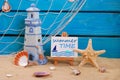 Seaside summer holidays still life with text written on easel Royalty Free Stock Photo