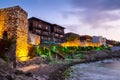 Seaside sunset landscape - fortress wall and tower with illumination