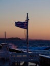Seaside Tables and Greek Flag at Sunset Royalty Free Stock Photo