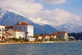 Seaside town at the foot of the snowy mountains. Montenegro, Bay of Kotor, embankment of Tivat city Royalty Free Stock Photo