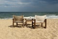 Seaside view with two empty chairs and table Royalty Free Stock Photo