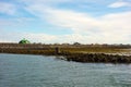 A seaside village protected by a berm in Iceland