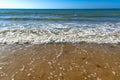 Seaside and waves, beach with sand, water, shell Royalty Free Stock Photo