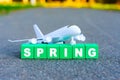 Season Change: Toy Plane and Letters Spelling SPRING Royalty Free Stock Photo