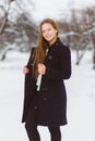 Season christmas or holidays and people concept - smiling young girl in winter clothes outdoor Royalty Free Stock Photo