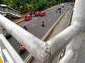 Iron pedestrian bridge against a highway in the background