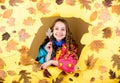 Season forecast. kid in autumn leaves. autumn beauty. Happy childhood. little girl in trendy raincoat. child in positive Royalty Free Stock Photo