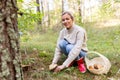 Young woman picking mushrooms in autumn forest Royalty Free Stock Photo