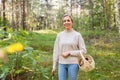 Woman with basket picking mushrooms in forest Royalty Free Stock Photo