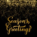 SeasonÃ¢â¬â¢s Greetings calligraphy hand lettering on shiny gold sparkles background. Merry Christmas and Happy New Year typography Royalty Free Stock Photo