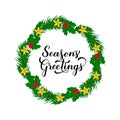 SeasonÃ¢â¬â¢s Greetings calligraphy hand lettering with wreath of fir tree branches. Merry Christmas and Happy New Year typography Royalty Free Stock Photo
