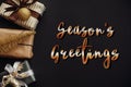 Season`s greetings text, handwritten golden sign at christmas bo Royalty Free Stock Photo