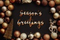 Season`s greetings text, handwritten golden sign at christmas go Royalty Free Stock Photo