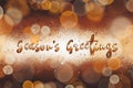 Season`s greetings text, handwritten golden sign at christmas sh Royalty Free Stock Photo