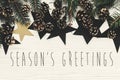 Season`s greetings text on modern christmas flat lay with green Royalty Free Stock Photo