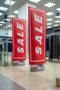 Season sale, black friday and shopping concept. Anti-theft sensor gates at the entrance to the clothing store with red sale sign. Royalty Free Stock Photo