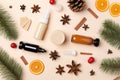 season skincare concept. Top view photo of cosmetic bottles Christmas ornaments baubles snowflakes mistletoe fir branches pine con