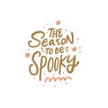 The season to be spooky hand drawn gold halloween phrase. Modern brush calligraphy text.