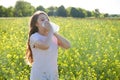 Seasonal allergy to pollen, the girl sneezes and closes her nose with a napkin