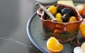 Seasonal appetizer platter with olives, cheese, meat and oranges