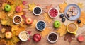 Seasonal autumn background. Frame of maple leaves and a cake, berries, raisins, apples, fruits, coffee and nuts over Royalty Free Stock Photo