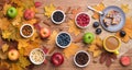 Seasonal autumn background. Frame of maple leaves and a cake, berries, raisins, apples, fruits, coffee and nuts over Royalty Free Stock Photo