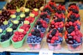 Seasonal berries in trays on the market Royalty Free Stock Photo