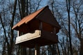 Seasonal bird feeder with made of right roof tiles made of burnt clay.