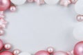 Seasonal Christmas background with white and pink tree baubles forming border around empty copy space Royalty Free Stock Photo