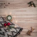 Seasonal Christmas border composed of decorative gifts, deer, candle and scarf, pine branches ornaments over a wooden background Royalty Free Stock Photo