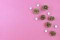 Seasonal Christmas flat lay with fir cones and gittering small white snowballs on right side and empty copy space on left side Royalty Free Stock Photo