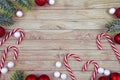 Seasonal Christmas flat lay with traditional red tree ornament baubles, white lace doily, candy canes and fir branches Royalty Free Stock Photo