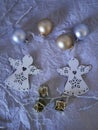 Seasonal composition of the decor of two white angels Christmas decorations, gold and silver balls on a light background top view Royalty Free Stock Photo