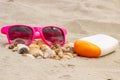 Seasonal concept, heap of shells, sunglasses and sun lotion Royalty Free Stock Photo