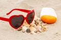 Seasonal concept, heap of shells, sunglasses and sun lotion Royalty Free Stock Photo