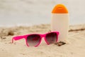 Seasonal concept, shells, pink sunglasses and sun lotion Royalty Free Stock Photo