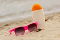 Seasonal concept, shells, pink sunglasses and sun lotion Royalty Free Stock Photo