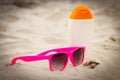 Seasonal concept, shells, pink sunglasses and sun lotion Royalty Free Stock Photo