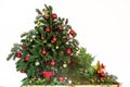 Seasonal decoration with christmas baubles red and green, fir branches and santa dwarf