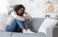 Seasonal Depression. Lonely Black Woman Sitting On Couch With Sad Face Expression Royalty Free Stock Photo