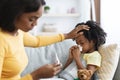 Seasonal Flu. Worried Black Mom Taking Care Of Ill Child At Home Royalty Free Stock Photo