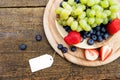 seasonal fresh fruits in a bowl on wooden table, sign with copyspace Royalty Free Stock Photo