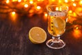 Seasonal and holidays concept. Christmas and autumn theme. One glasses mulled wine on a rustic wooden table. Selective focus