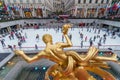 Seasonal ice skating rink with a golden statue at Rockefeller Center, Manhattan, New York, USA