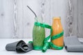 Seasonal Matcha green vegan smoothie and pumpkin carrot smoothie drink detox Breakfast with measuring tape and rubber Royalty Free Stock Photo